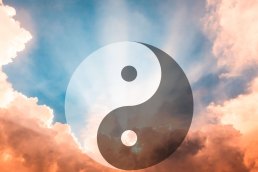 Yin-Yang symbol floating in serene sky representing the five sacred principles of ancient Chinese philosophy for modern life balance